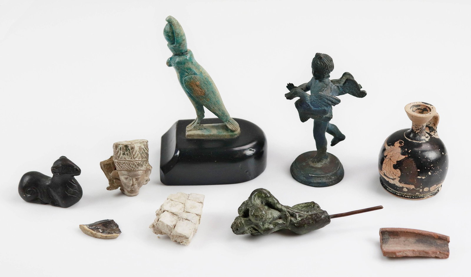 (9) Pcs Reproduction Anthropological Items: (9) Pcs reproduction anthropological items c/o (2) pottery shards, (1) floor tile shard, cast erotic sculpture, bronze ram, bronze putti with bird, pottery head, terra cotta ewer and egyptian bird on 