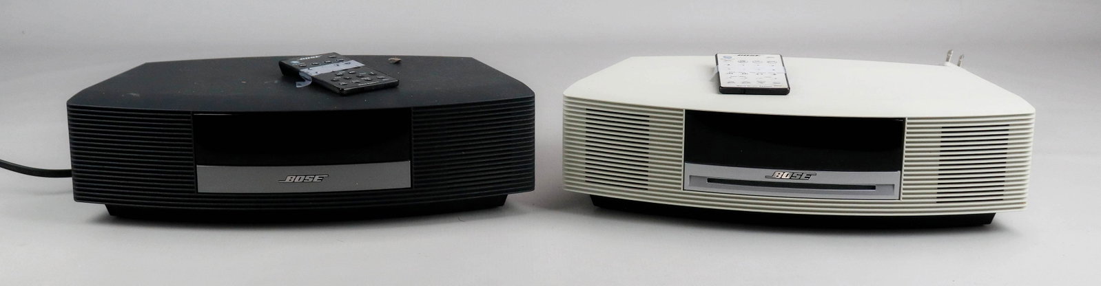 (2) Bose Radio Systems: (2) Bose Radio systems c/o Bose Wave Radio II in black with remote and Bose Wave music system, in cream with remote.