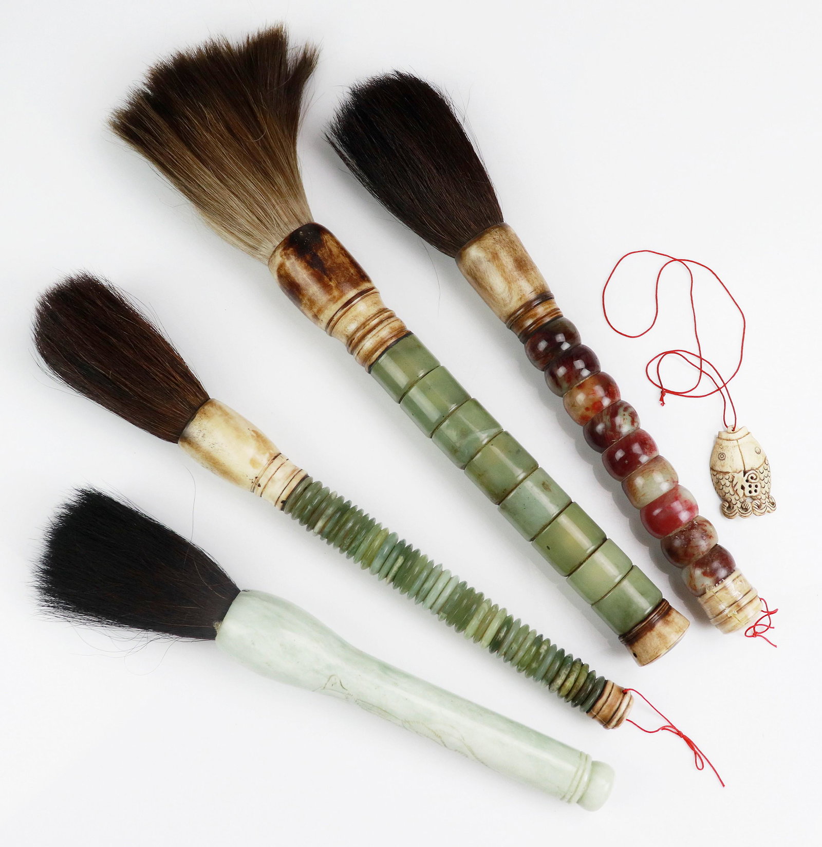 (4) Asian Brushes & Bone Fish Pendant: (4) Asian calligraphy brushes, stone handles, longest 18-1/2", and a bone double fish pendant 2-1/4" x 1-1/2"