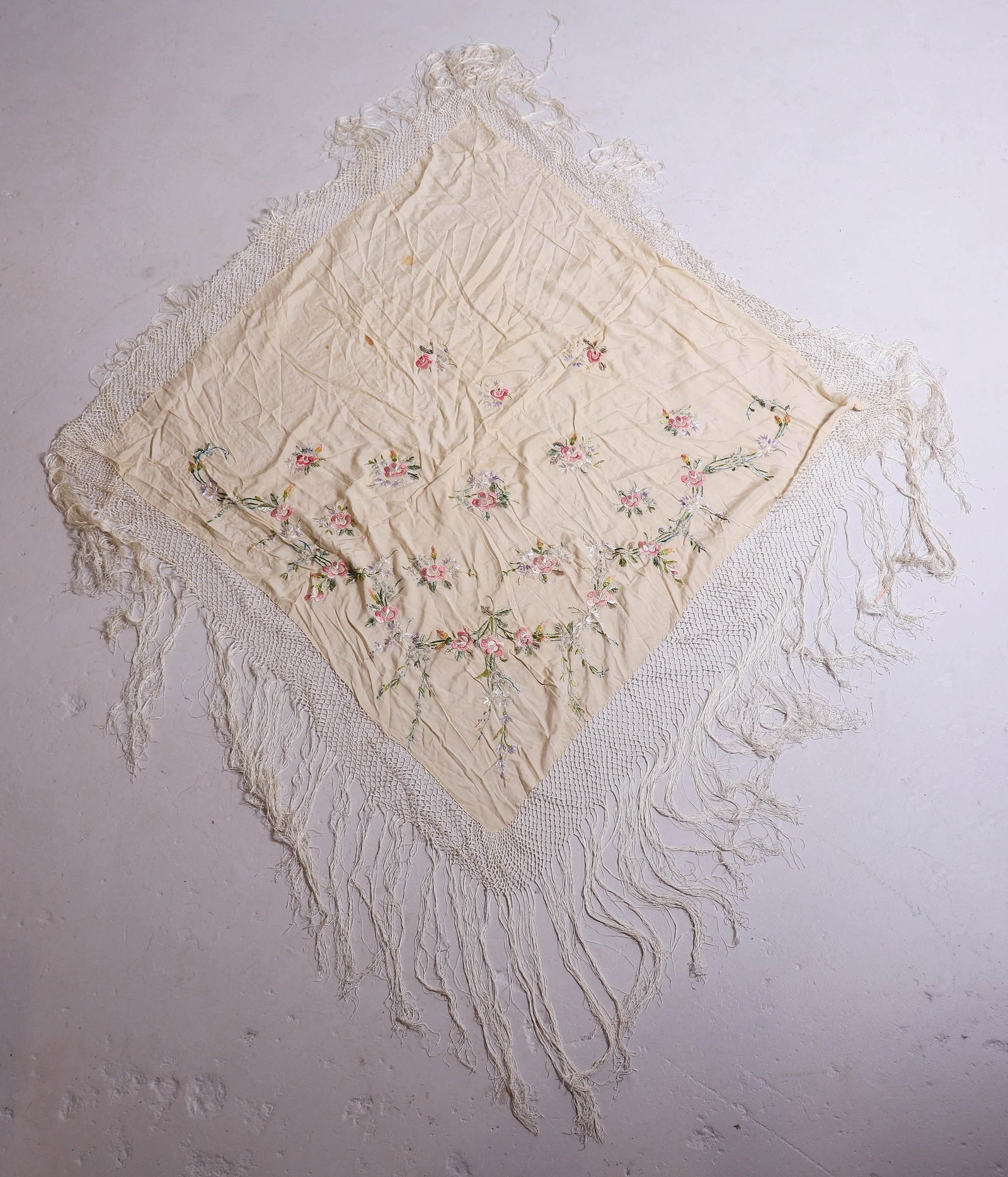 Embroidered Silk Piano Shawl: Embroidered silk piano shawl in multi color floral decoration, knotted edge and 15" silk fringe surround, spot stains. EXCLUDING fringe item measures 42"x42", late 19th early 20th c.