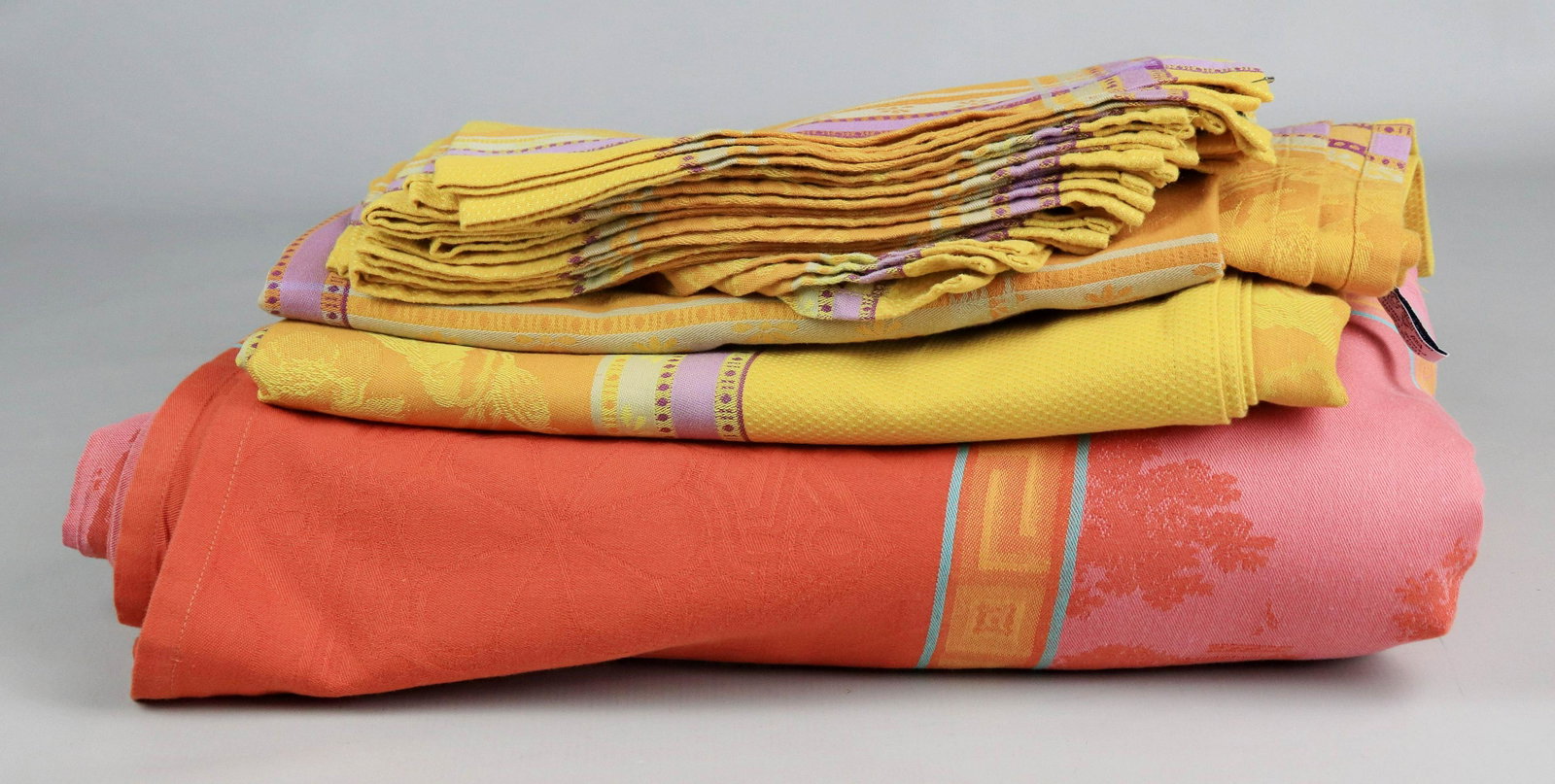 (5) Le Jacquard Francais Tablecloths and Napkins: (5) Le Jacquard Francais tablecloths and napkins c/o (2) turmeric and lavender jacquard tablecloths, 55" x 60" and 59" x 54" with (8) dinner napkins and (3) pink, coral and blue jacquard tablecloths, 