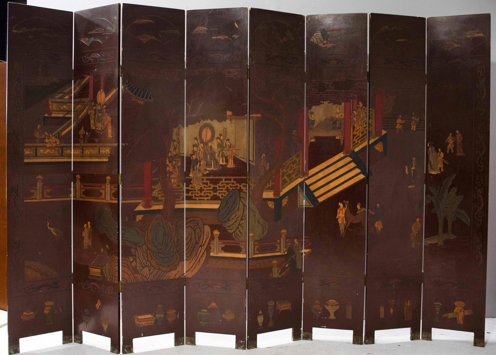 Chinese 12ft. Coromandel folding screen: Chinese 12ft. Coromandel folding screen, brown lacquer with carved and painted scenes, floral decoration on back, 96" x 144", good condition with various small lacquer damages