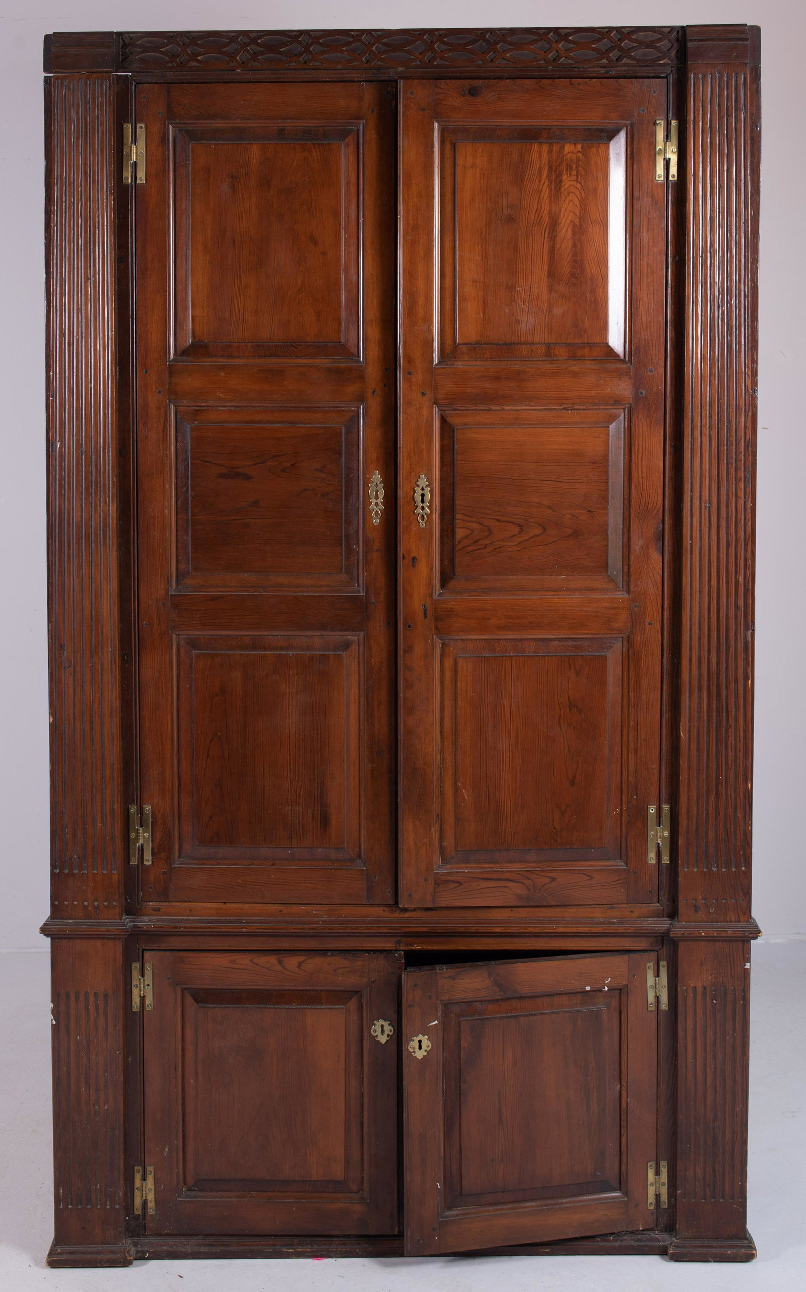 Yellow Pine Architectural Cupboard: Yellow Pine Barrel Back Architectural Corner Cupboard, raised panel doors concealing butterfly shelves, flanked by reeded pilasters, the cornice with flat blind fret carving, probably MD Eastern Shore