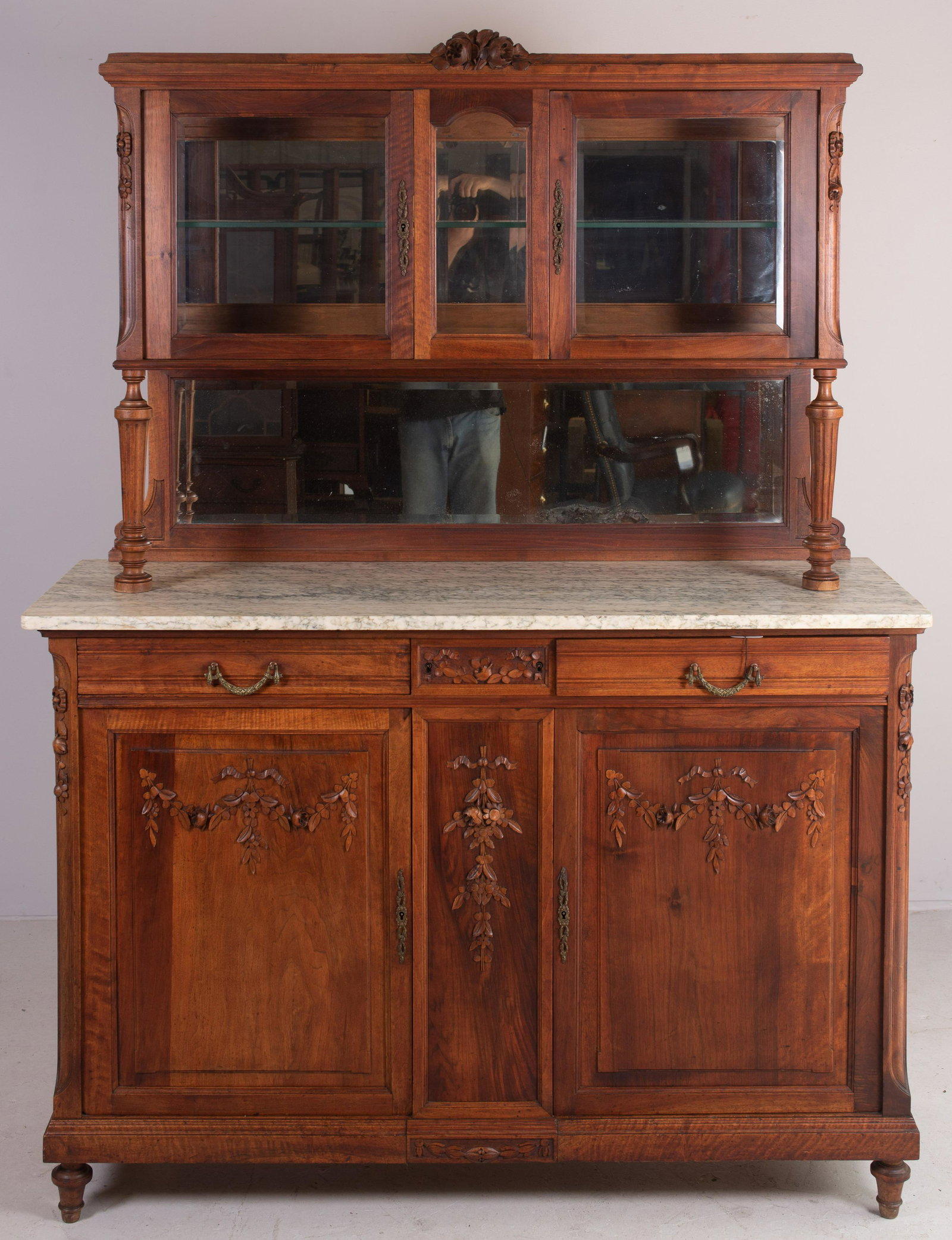 Carved walnut French Sideboard , 19th c: Carved walnut French Sideboard with black veined white marble top, curio top section with beveled glass and a mirrored crest, the base with two drawers over two doors, 60" wide, 78" tall, late 19th c