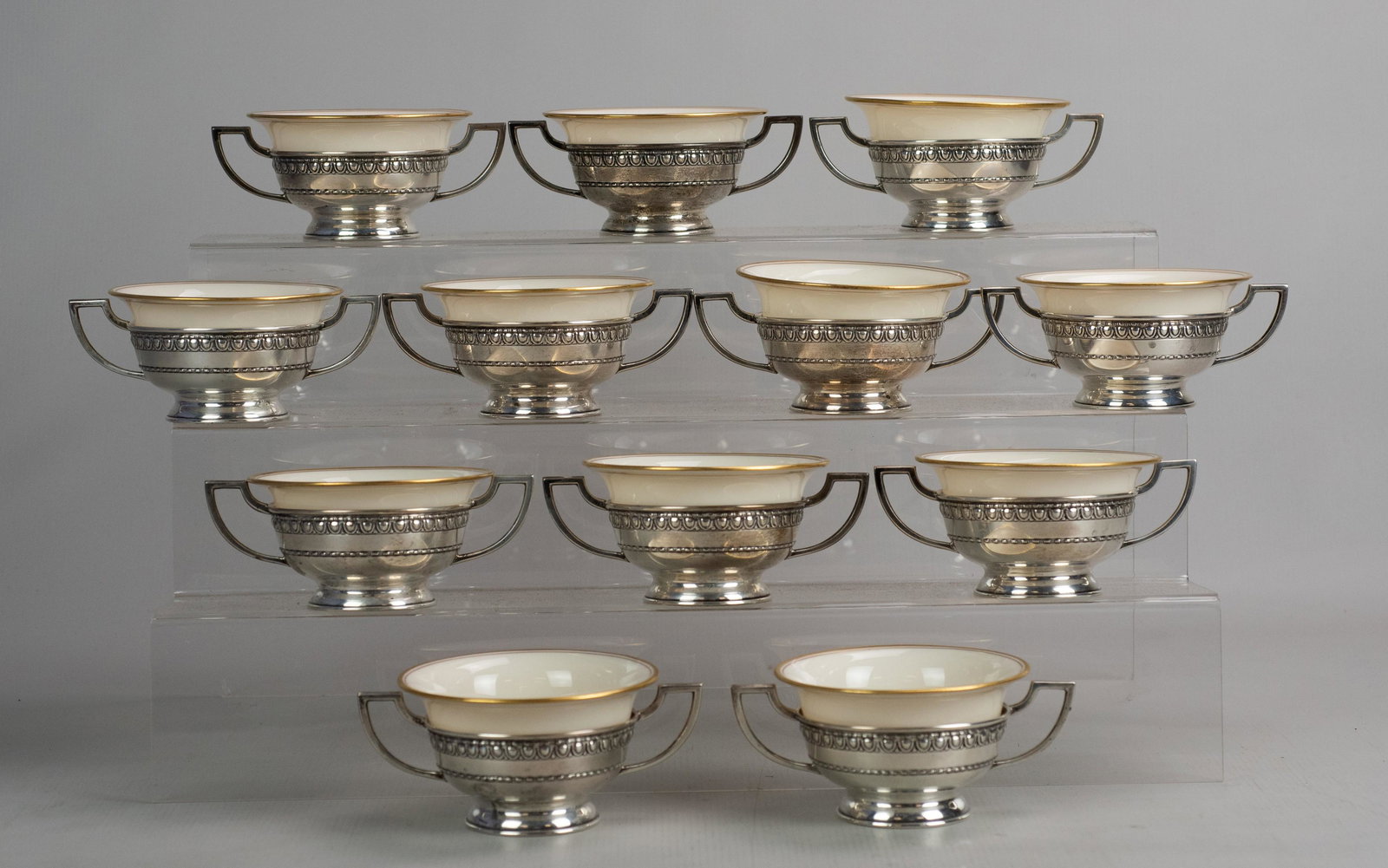 (12) Sterling Cream Soup Frames: (12) Sterling cream soup frames, gilt edge Lenox liners, by Matthews Company with double handle sides , 18.4 T.O