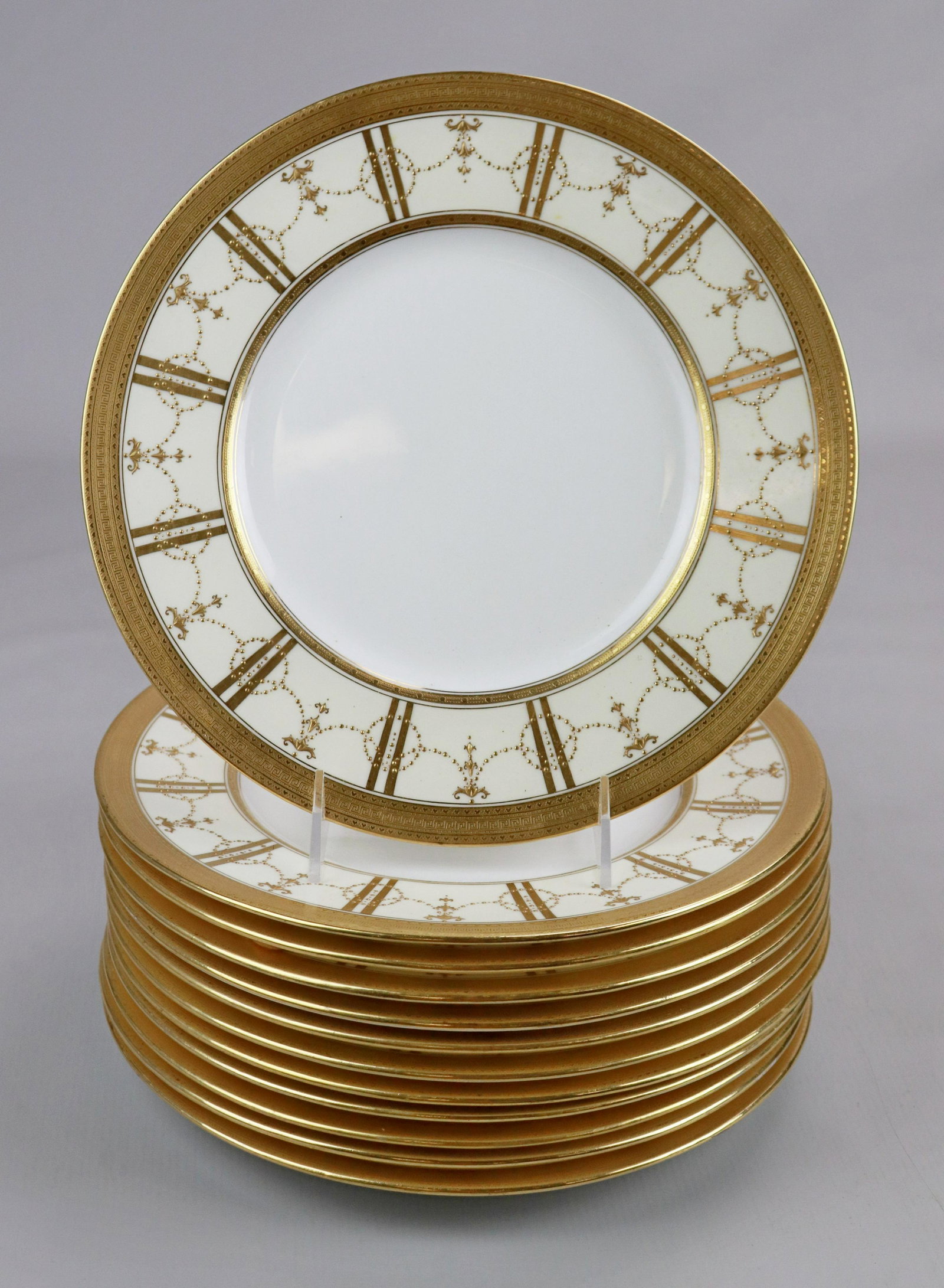 (12) Mintons for J.E Caldwell Dinner Plates: (12) Mintons for J.E Caldwell dinner plates in white with cream and gilt garland decorated rim, greek key gilt edge, 10-1/4"