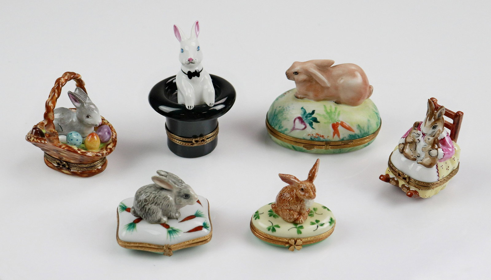 (6) Limoges Figural Rabbit Trinket Boxes: (6) Limoges figural rabbit trinket boxes c/o white rabbit in top hat marked Limoges France Peint Main Chamart Exclusive, 3-3/4", grey rabbit on carrot decorated pillow reading Peint Main Limoges Franc