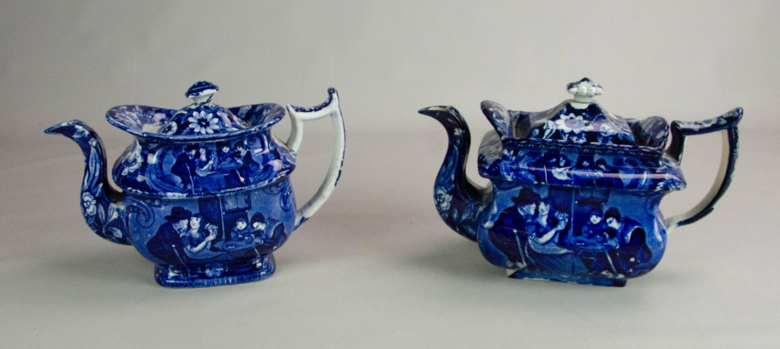 (2) Blue Staffordshire Teapots: (2) Blue Staffordshire teapots, c/o one titled "Christmas Eve" by Clewes, 11-1/2" l x 7" h, no damage noted, one with Christmas eve scene, unsigned, lid with reglued finial and edge chip, piece presen