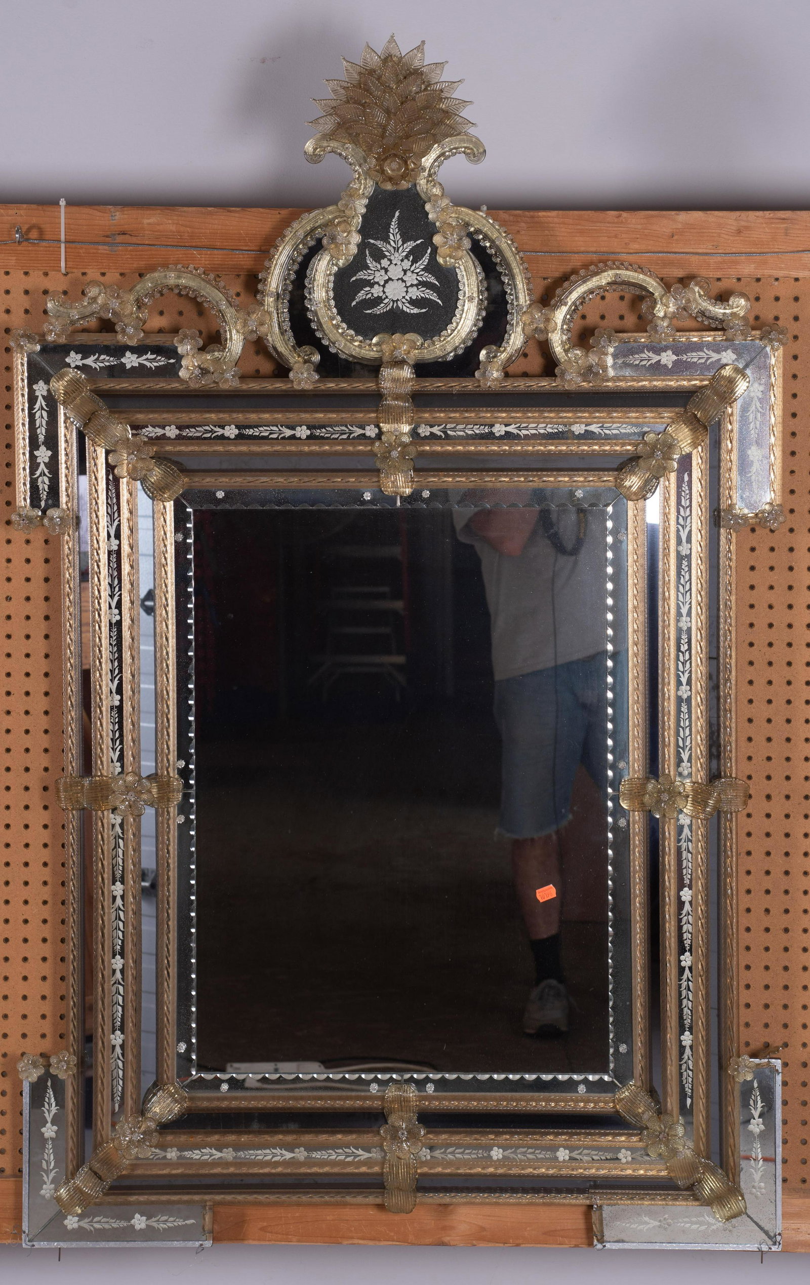 Venetian etched hanging wall mirror: Venetian etched hanging wall mirror, glass flowers and rosettes, 64"h x 39"w, some damages at lower corner portion, some silvering to mirrors