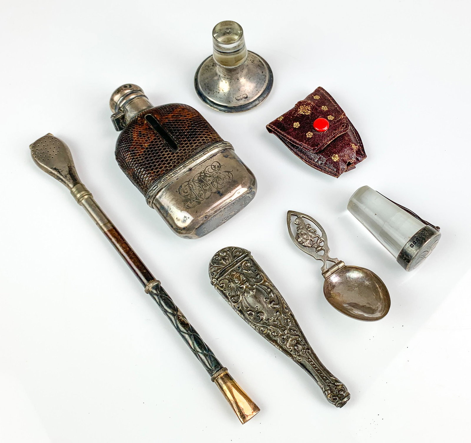 Sterling Mounted Flask and Silver Medicine Spoon: Sterling mounted flask and silver medicine spoon c/o sterling mounted snakeskin wrapped flask, 4-1/4" initials at front and silver lion topped medicine spoon. Also includes (2) initialed sterling topp