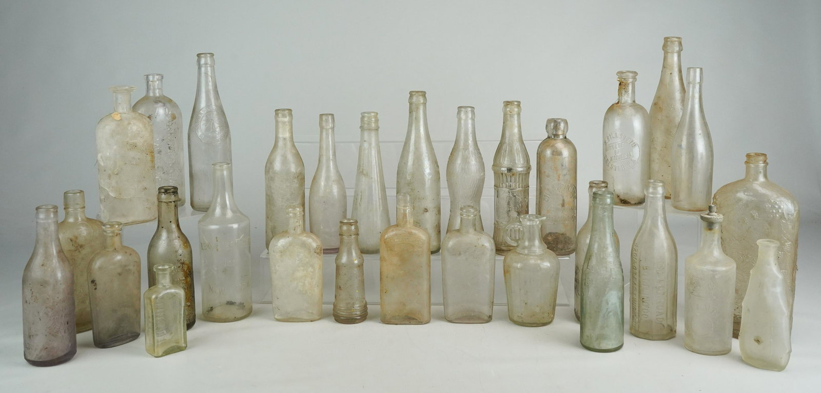 (30) 19th c. Clear Glass Bottles: (30) 19th C clear glass bottles including Lew's brothers inc. NY, Pride of Long Island Tomato Catsup, ED. Pinaud Paris, Horton Cato, JP Thatcher druggist West Chester, with crack, Joseph Campbell Comp