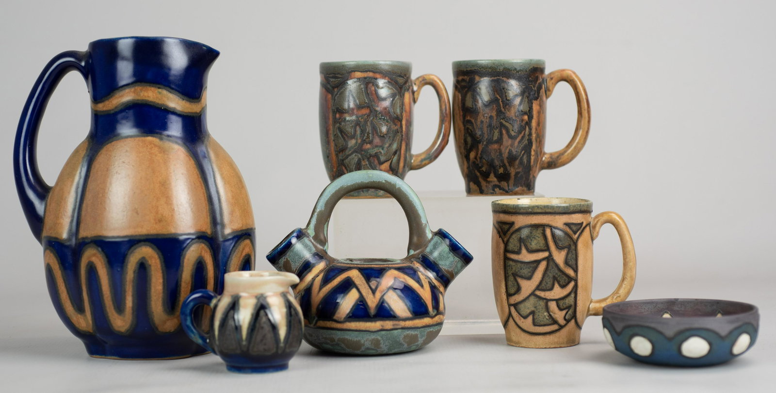 (7) Pcs HB Quimper Odetta Pottery: (7) Pcs HB Quimper pottery Odetta gres ware, c/o lobed pitcher, 8-1/8" h, (3) mugs, 3-3/4" h, miniature creamer, 2-1/4" h, double spout teapot (missing lid), 5" h, bowl, 3-3/4" dia x 1-1/4" h