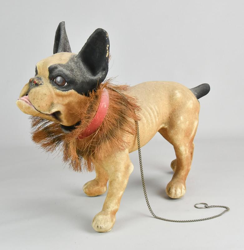Toy French growler bulldog pull toy, early 20th c: Toy French growler bulldog pull toy, plush covered composition w/glass eyes & bobbing head, growls when chain is pulled, c.1910, VG+ wkg cond, 18" long x 15" high, missing left front wheel.