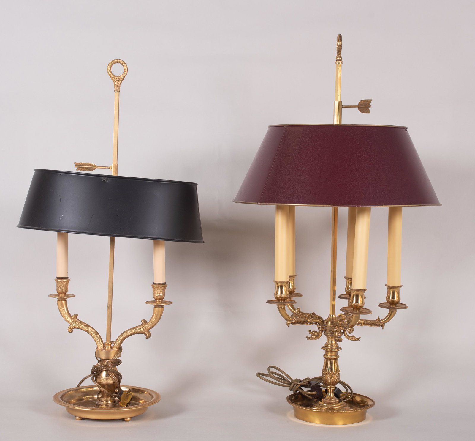 (2) Bouillotte Table Lamps: (2) Bouillotte table lamps to include 5-arm brass bodied lamp with leaf and swan form decoration, painted shade and fletching form finial. 30" h and 2-arm brass bodied lamp in embossed scroll and leaf