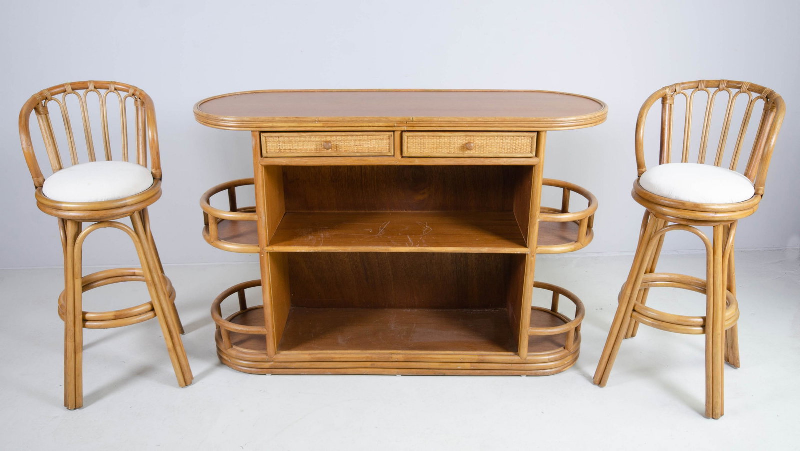 (3) pc Bamboo bar set: (3) pc Bamboo bar set, c/o bar with two woven drawers over one shelf, sides with 2 shelves each, pair bar stools with upholstered seats, bar 40-1/2" h x 59" w, light wear, some soiling to upholstery