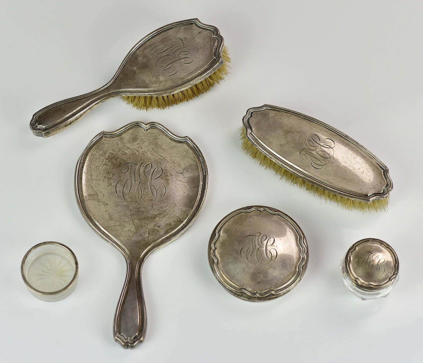 (5) Pc Reed and Barton Sterling Vanity Set: (5) Pc Reed and Barton sterling vanity set to include garment brush, hair brush, hand mirror, crystal powder jar and crystal ring dish with sterling rim. Grouping also includes sterling powder jar lid