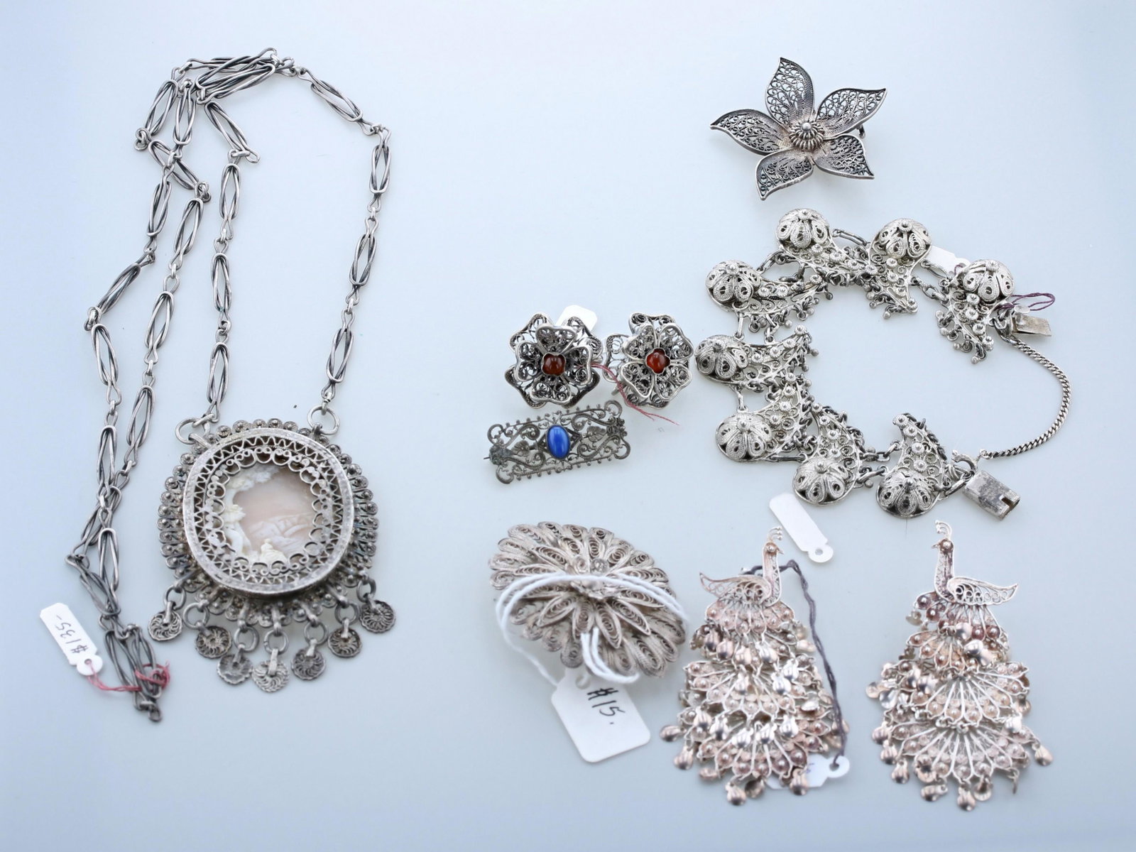 Vintage Filigree Jewelry: (7) Pc Vintage Filigree Jewelry Lot C/O; (1) 2.5" cameo pendant on a long 27" hand forged chain, (3) Filigree pierced brooches, one needs repair, (1) Dangle peacock dangle earrings, (1) 800 silver scr