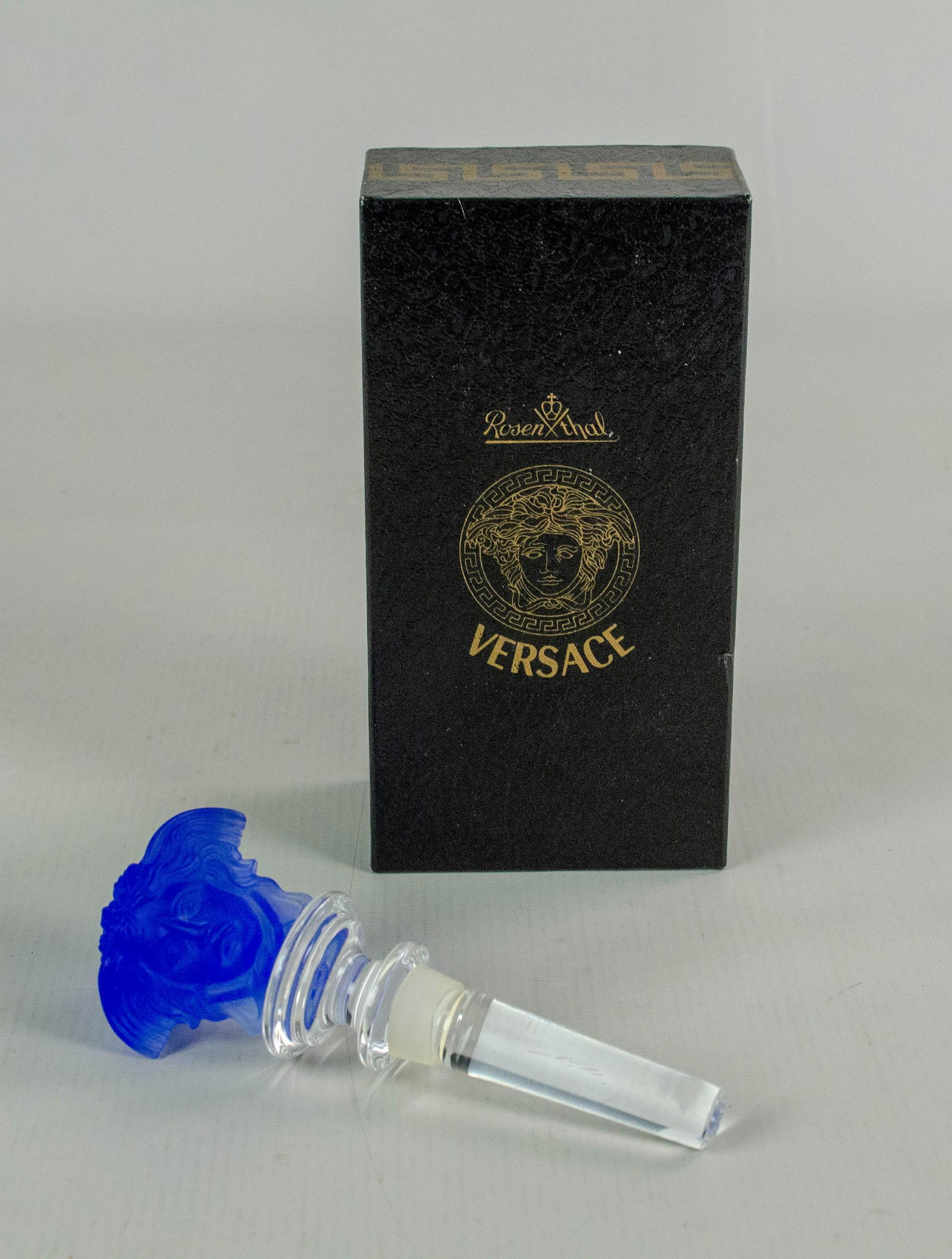 Rosenthal Versace Medusa Stopper: Rosenthal Versace bottle stopper, cobalt blue Medusa head with clear crystal stem, marked "Rosenthal Versace", 5-1/8" h, with original box