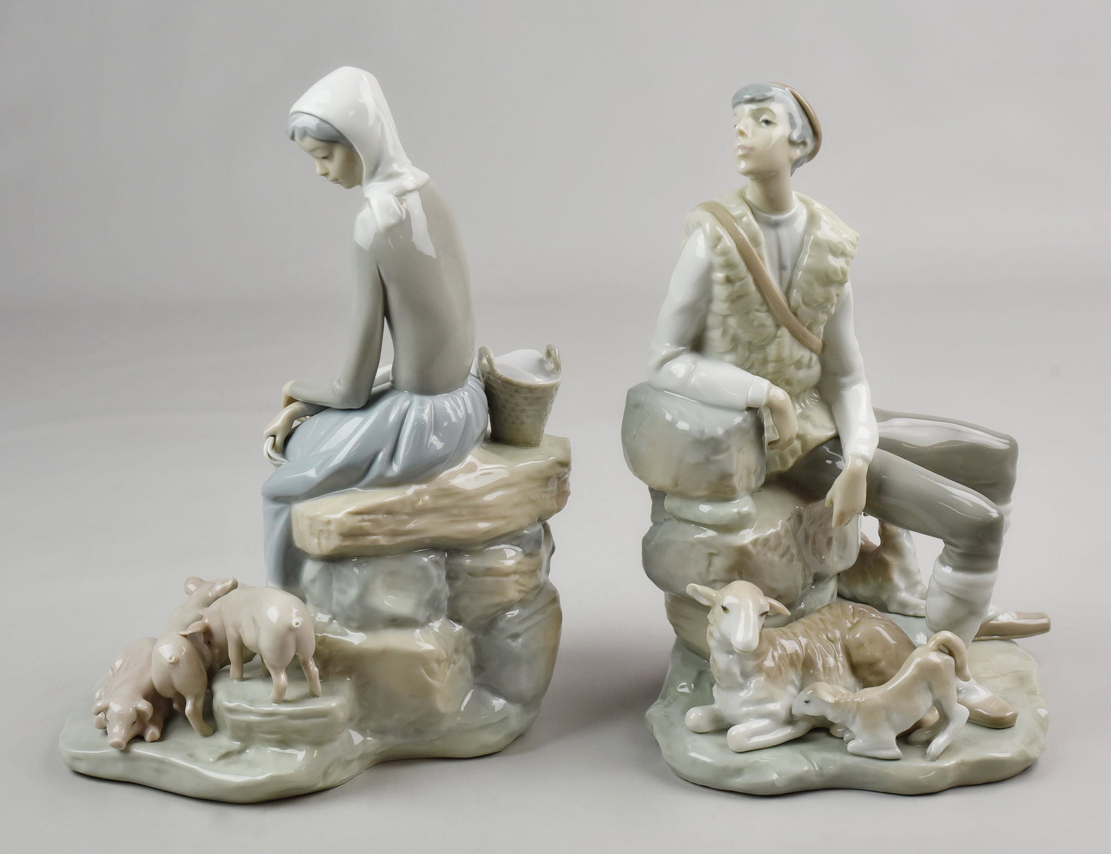 (2) Lladro Figurines: (2) Lladro figurines c/o Girl with Piglets, 10-1/2" h and Shepherd Boy with lambs and dogs, 10-1/2", with damages boy missing fingers on one hand
