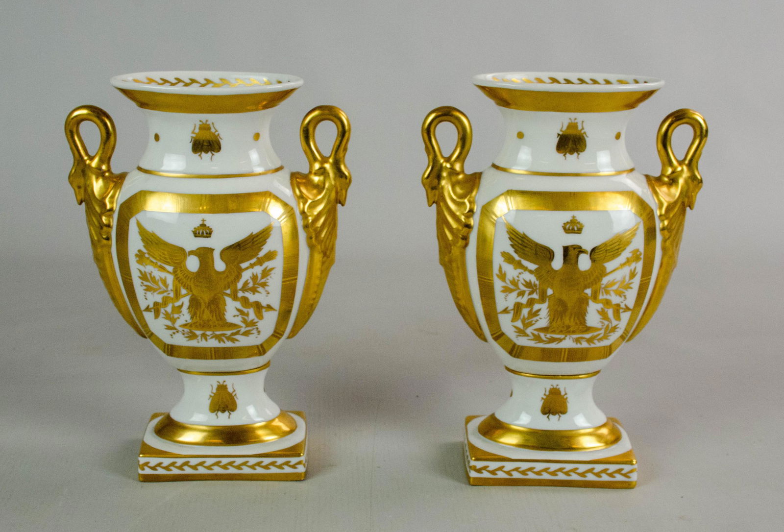 Napoleon Bee Porcelain Vase Pair: Napoleon Bee porcelain vase pair, comprised of gilt painted porcelain with bee, N, eagle, leaf and swan decoration. Marked at underside decor main, BH Paris, Hand Painted Limoges France, Made in Franc