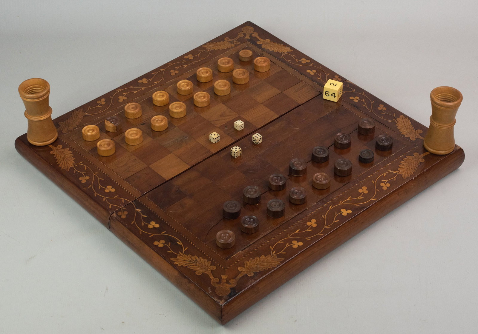 Inlaid Checkers & Backgammon Game Board: Inlaid checkers & backgammon game board, (17) game pieces,(4) 6-sided dice, (1) doubling cube, (2) shakers, a piece of inlay needs to be repaired (included), 20-1/4" sq when open, some age cracks