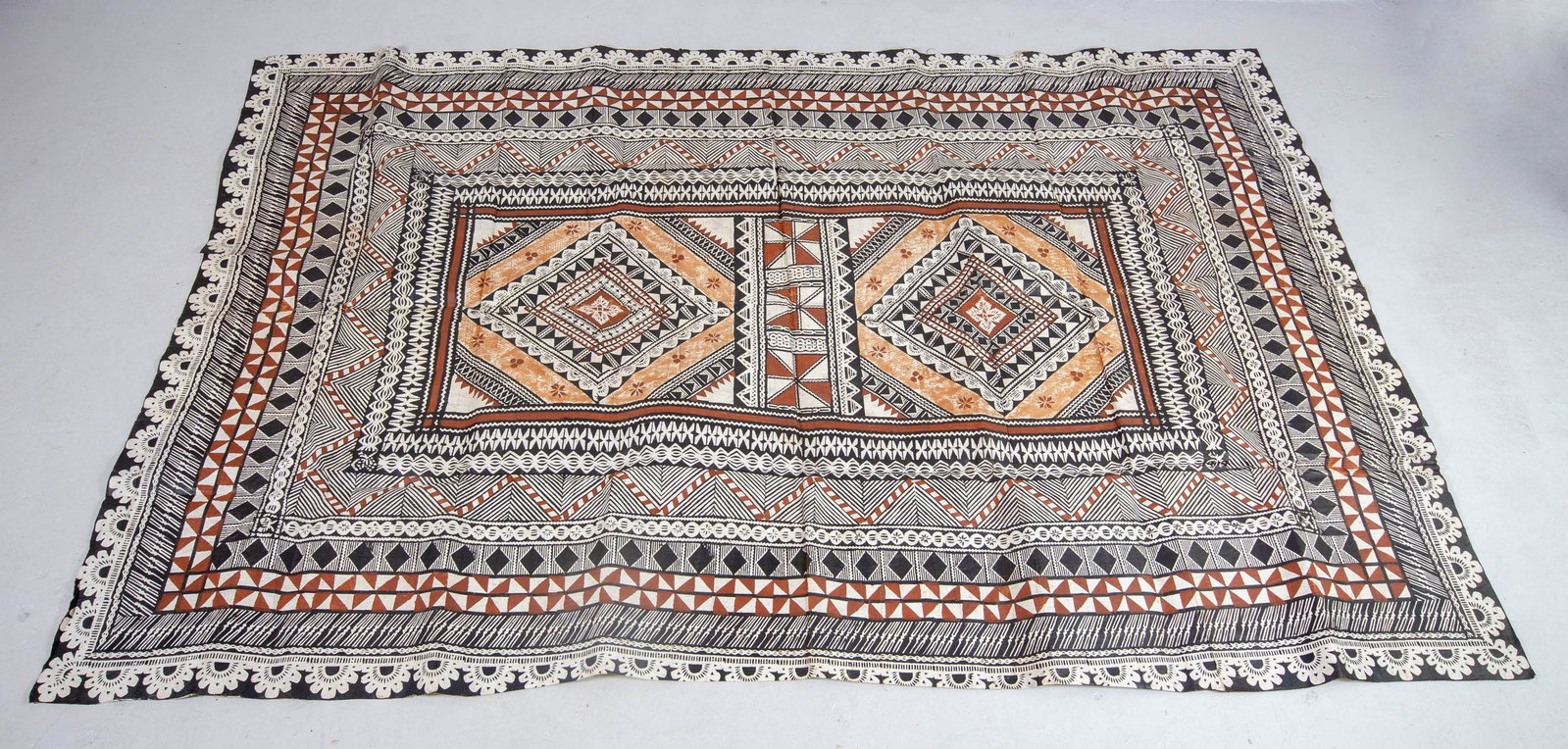 Fijian Tapa Cloth: Fijian Tapa cloth, (Masi) comprised of beaten bark decorated in brown, black and cream geometric pattern. 9 ft long, 6 ft wide