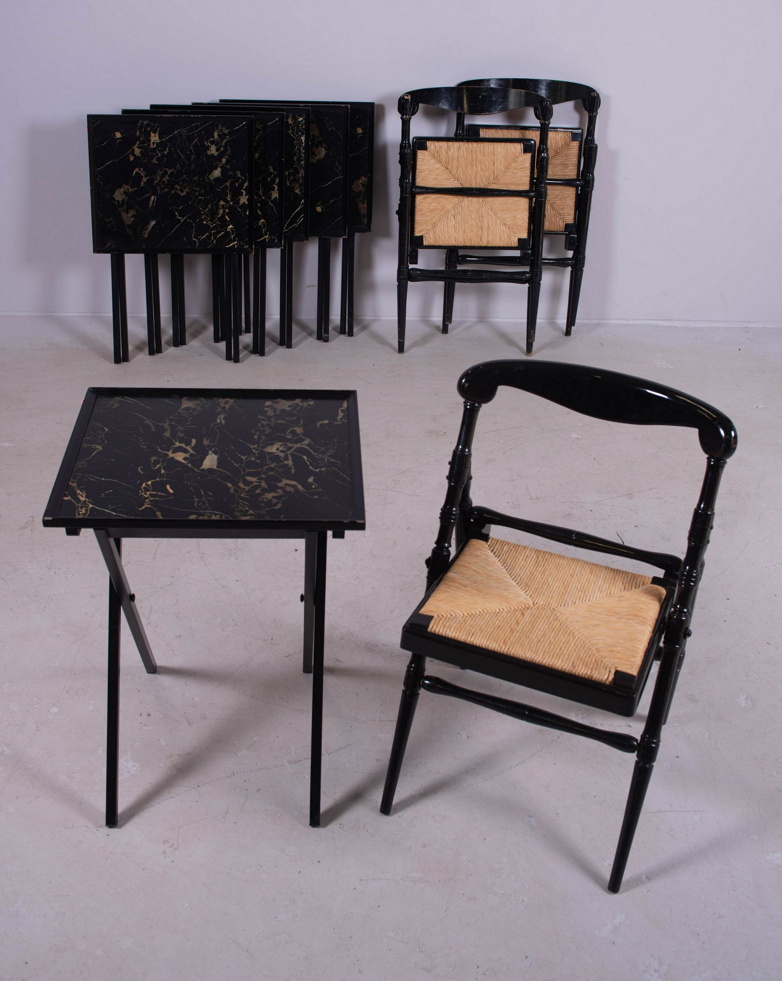 (3) Ebonized and caned seat folding chairs: (3) Ebonized and caned seat folding chairs, along with (6) ebonized folding tray tables w/ faux painted marbletop, tables open 26" h x 19" w, wear to paint