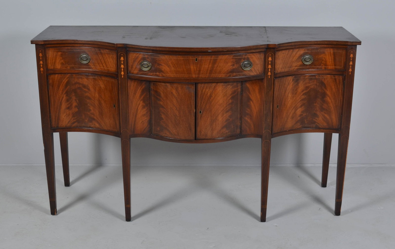 Mahogany Hepplewhite style inlaid bowfront sideboard: Mahogany Hepplewhite style inlaid bowfront sideboard, 39-1/4" h x 66" w, damages and wear