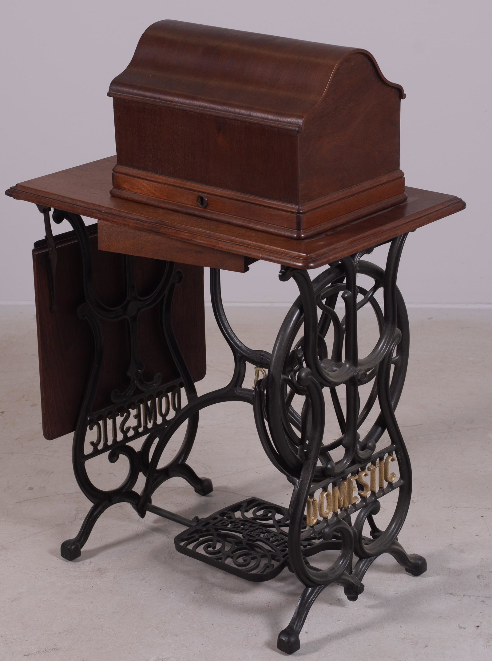 Domestic sewing machine on iron stand: Domestic sewing machine on iron stand, 40" h x 27" w