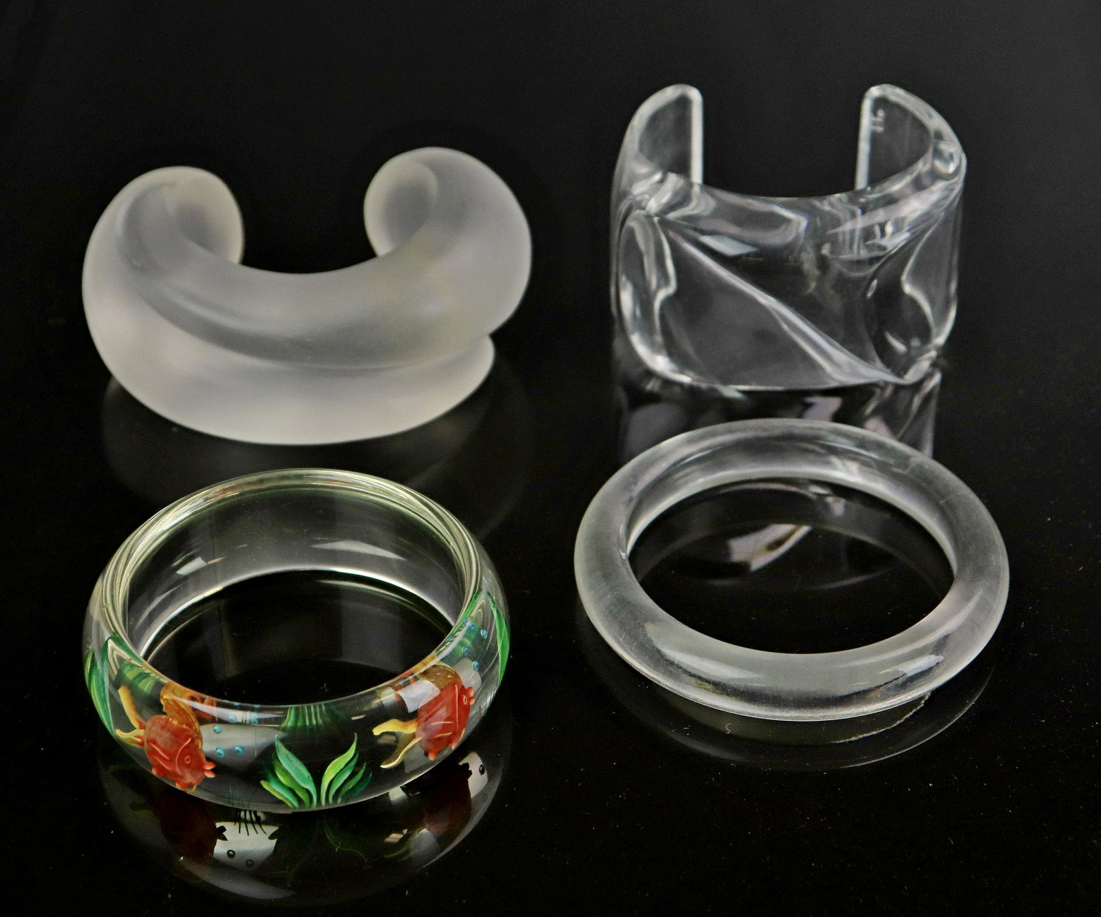 (4) Lucite Bangles: (4) Lucite Bangles, one with carved tropical fish design