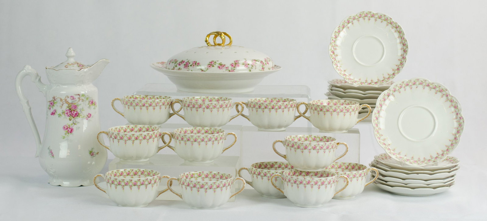 (29) Pcs Rose Decorated Porcelain: (29) Pcs rose decorated porcelain to include (12) Theodore Haviland Limoges cream soups, (15) saucers, porcelain coffee pot, unmarked, and GDA Limoges covered pancake, 10" diam, (1) Soup bowl with hai