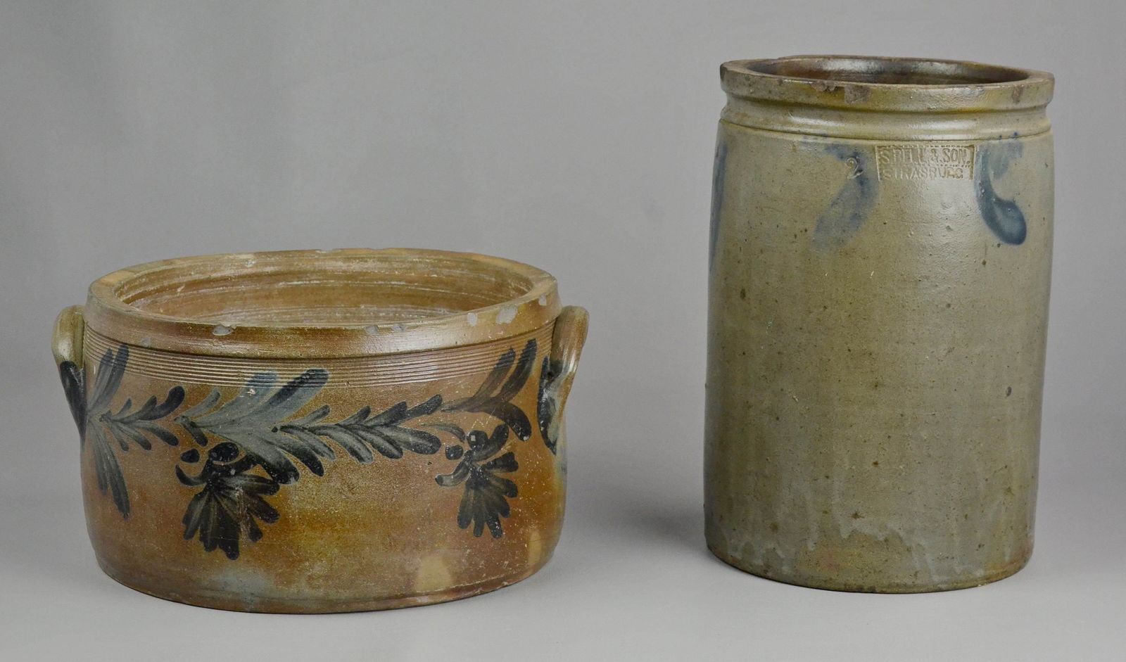 Blue Decorated Stoneware Crock and Cake Crock: Blue decorated stoneware crock and cake crock c/o stamped S. Bell & Son Strasburg VA storage crock, 2 gallon, with blue decoration at rim, chipped at rim, 11-3/4" h and double handled unmarked cake cr