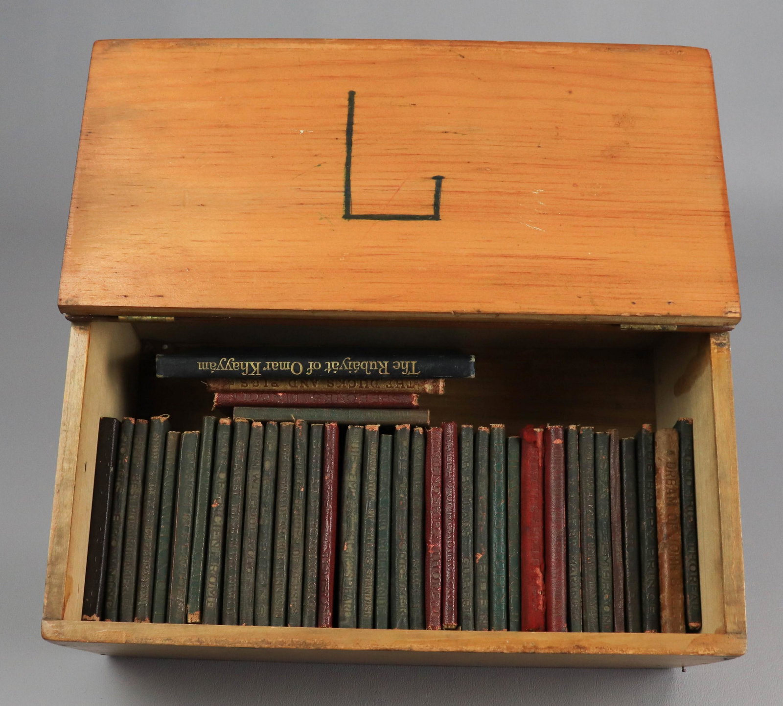 (40) Miniature Books: (40) Miniature books, c/o (38) Little Leather Library, Little Rosy's Travels The Ducks and Pigs 1870, Rubaiyat of Omar Khayyam in wood box with hinged lid