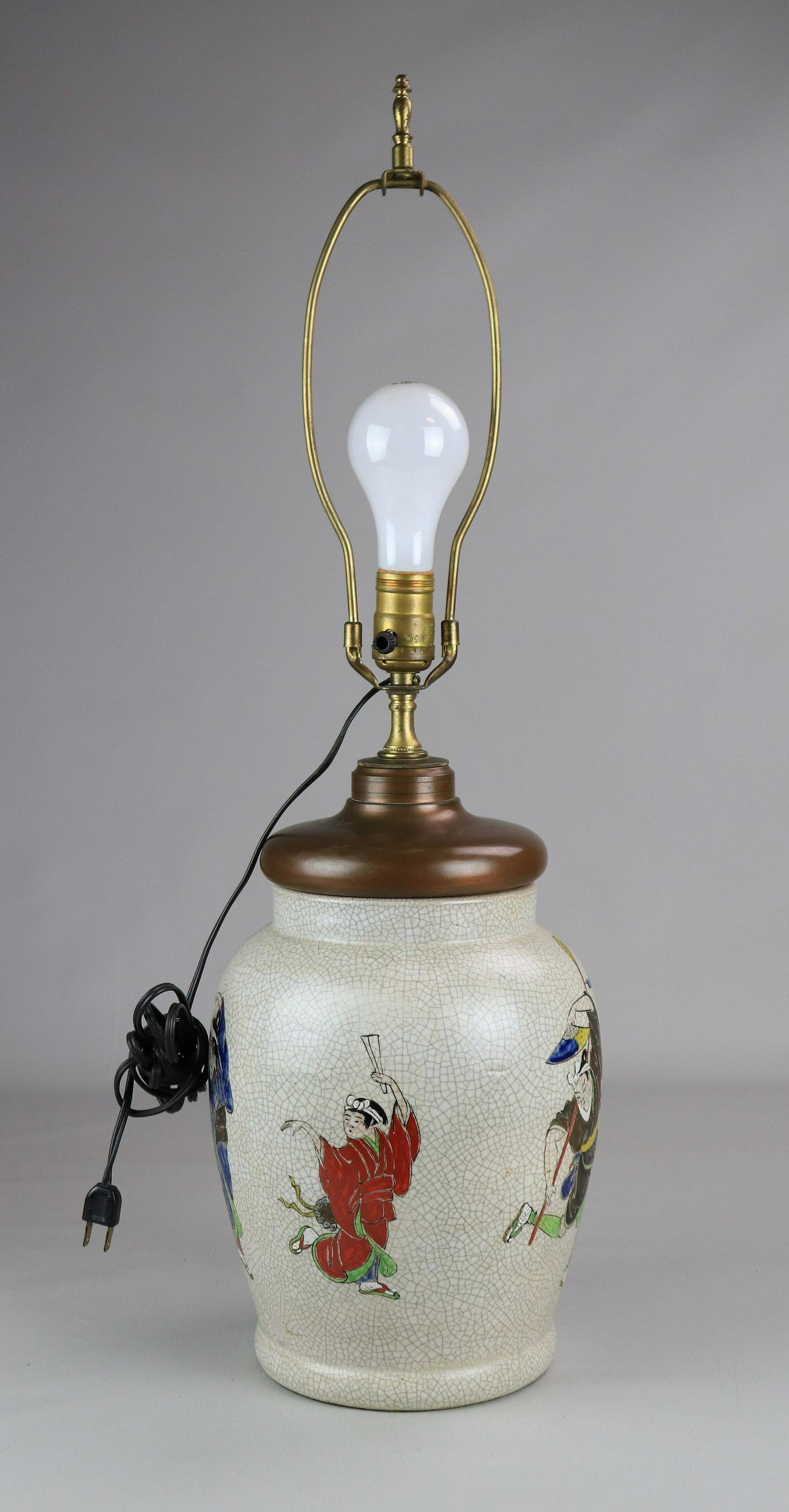 Enamel Painted Crackle Glaze Lamp: Enamel painted crackle glaze lamp with figural surround, copper patinated mount, 29" h including harp