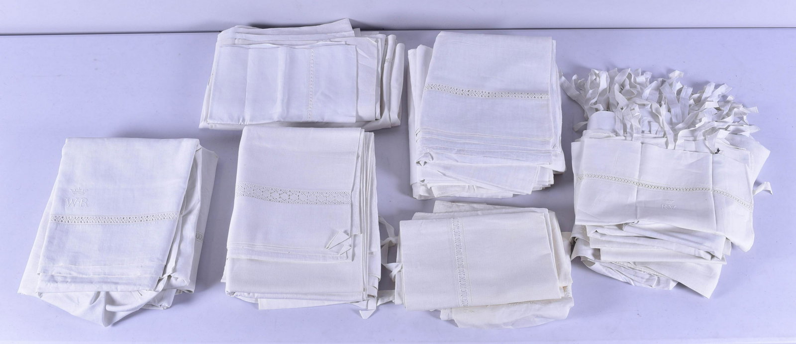 Bridal Sheet Set and Bed Linens: Bridal sheets and bed linens to include (9) bridal pillows with sifer, (4) linen pillowcases and (10)+ pure linen bed sheets with openwork. The sheets are large, oversize Queen