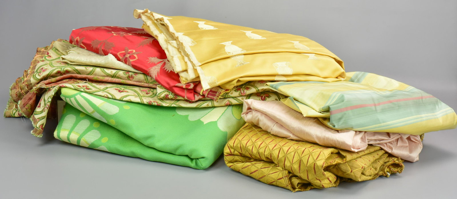 (8) Home Decor Fabric Portions: (8) Home decor fabric portions to include trailing floral and foliage embroidered tan silk, 4'5", silk linen textured animal print, 6ft, gold, shimmer and persimmon abstract silk jacquard, 7ft7", gold