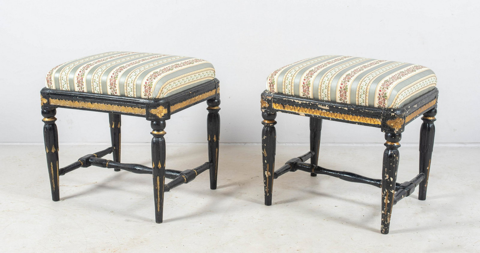 Pair Black and Gilt Painted Regency Style Footstools: Pair black and gilt painted regency style footstools, losses to paint, in silk jacquard, 18"x15-1/2"x17" h, late 19th/early 20th c