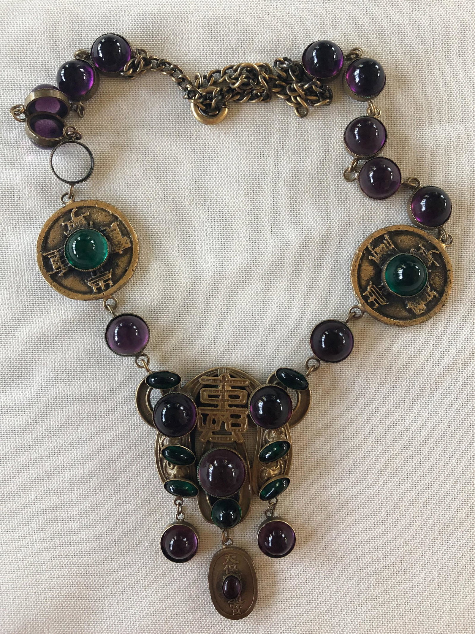 Joseff of Hollywood Asian Coin necklace w/purple: Joseff of Hollywood Asian Coin necklace w/purple/green stones, missing one stone, 24" l