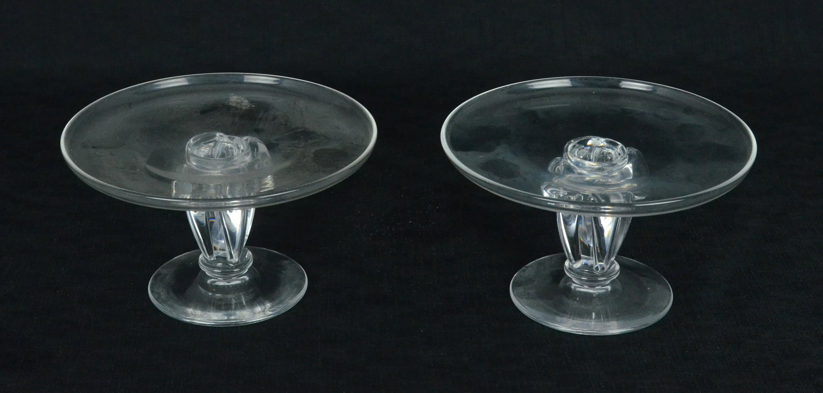 Steuben Pedestal Pair: Steuben pedestal pair, James McNaughton, foliate footed crystal pedestals, signed at underside, 3-3/4"hx6-1/2"diam