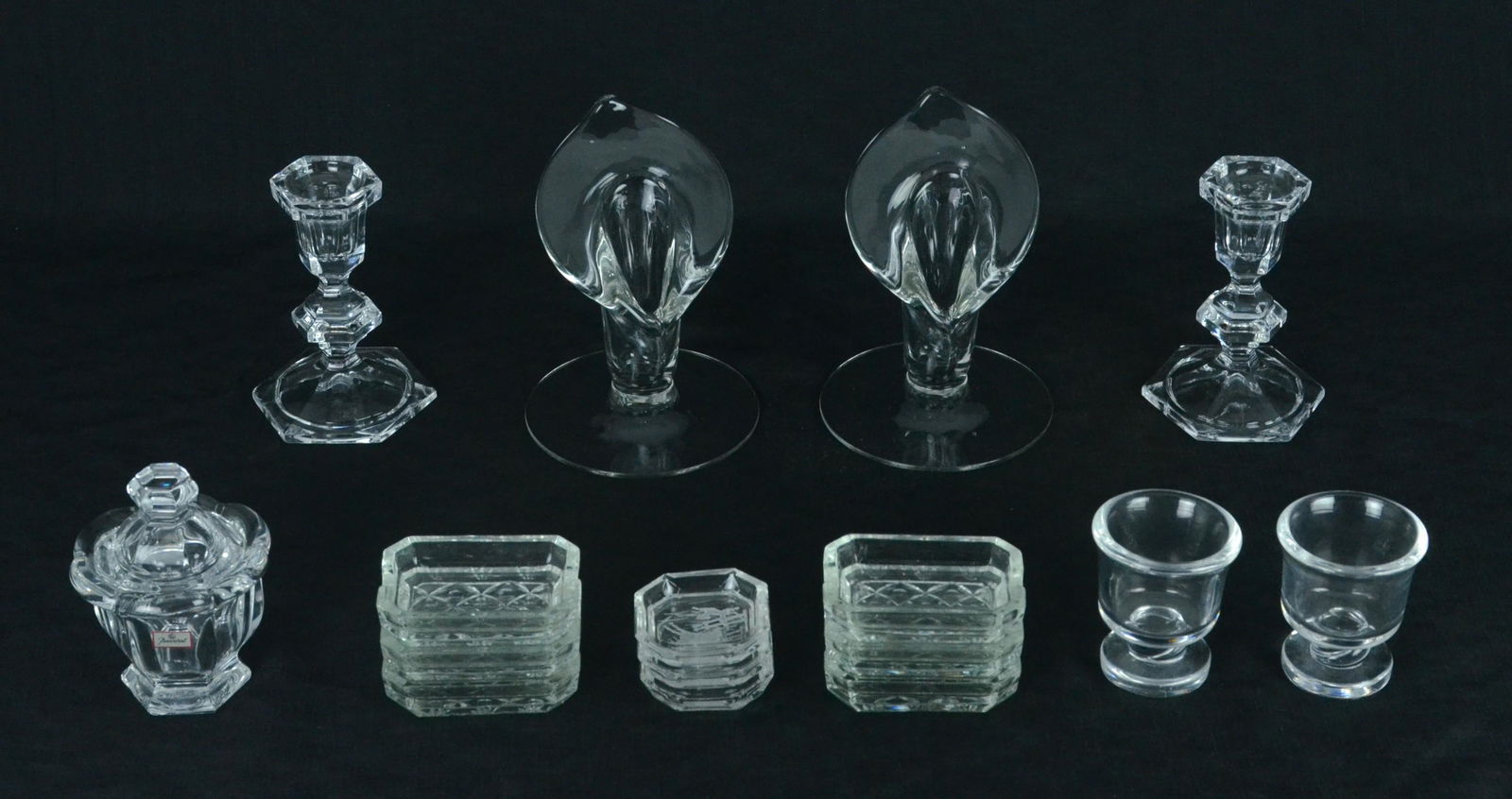 (16) Glass and Crystal Table Items: (16) Glass and crystal table items to include covered Baccarat condiment, (6) cut glass personal ashtrays, (3) etched hunt scene personal ashtrays, (2) footed Steuben toothpick holders, pair unmarked
