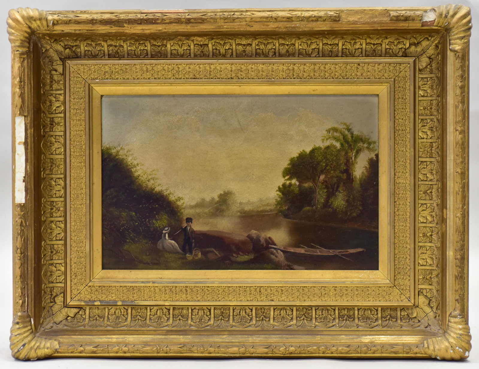 19th C American Landscape Painting: 19th C American landscape painting depicting a young couple picnicking by a lake, oil on board, unsigned, 9-1/4" x 14", framed 16-1/2" x 21-3/4", good condition, gesso damages on frame