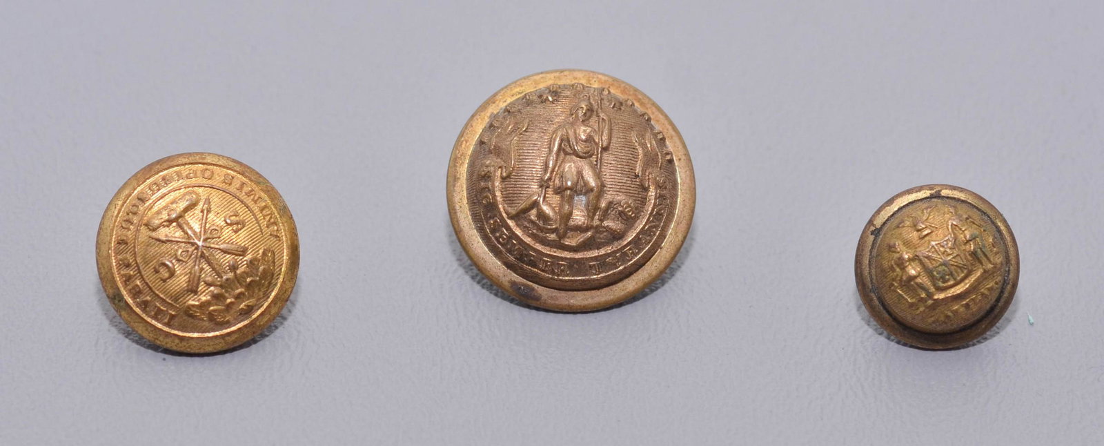 (3) Confederate Buttons: (3) Confederate buttons c/o (1) Maryland confederate button, Horstmann back mark, (1) South Carolina confederate vest button, Horstmann back mark and (1) Virginia confederate uniform button, Horstmann