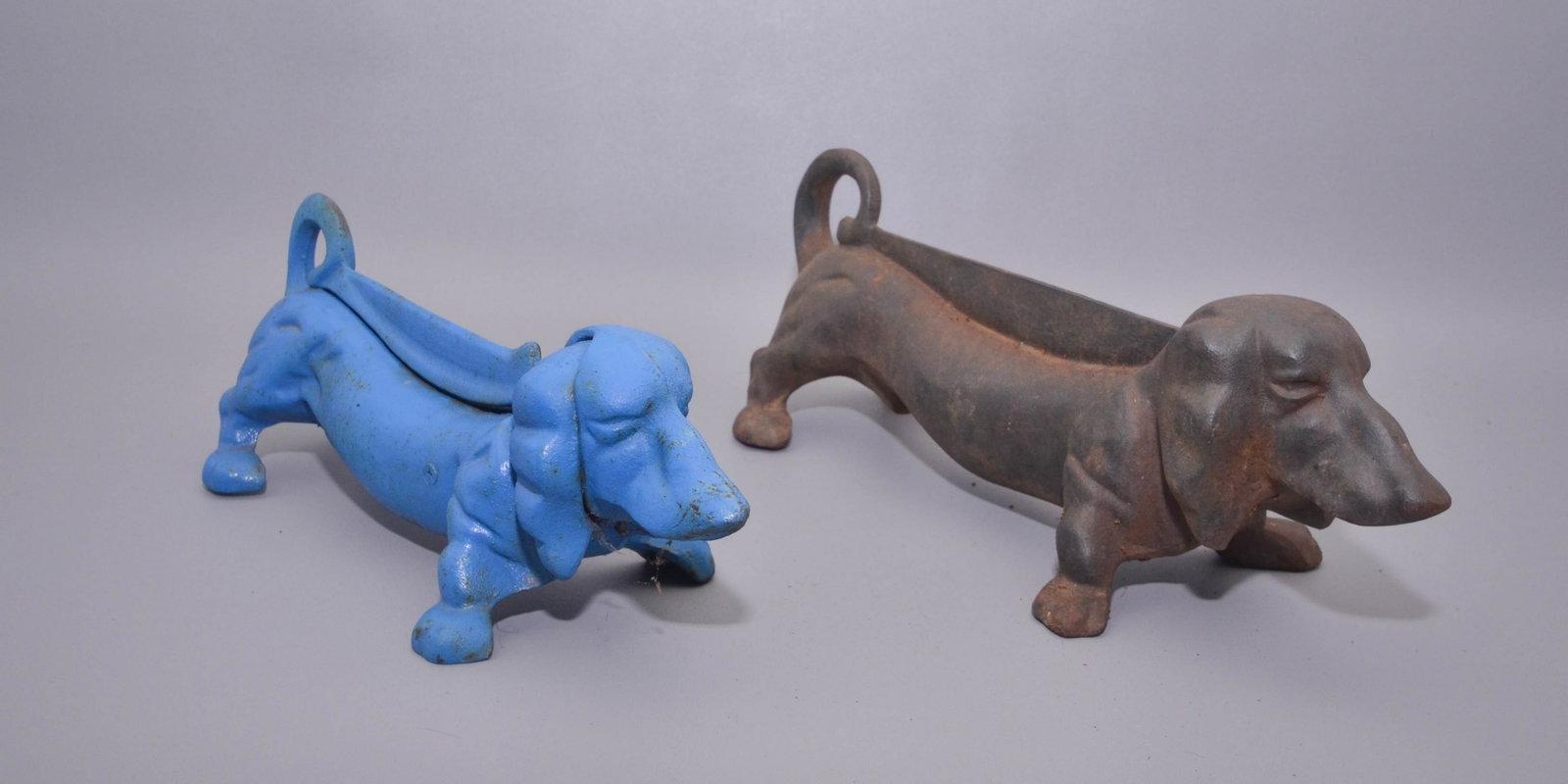 (2) Cast Iron Figural Dachshund Boot Scrapes: (2) Cast iron figural dachshund boot scrapes c/o (1) blue painted, (1) earlier in original patina, 14" and 16"