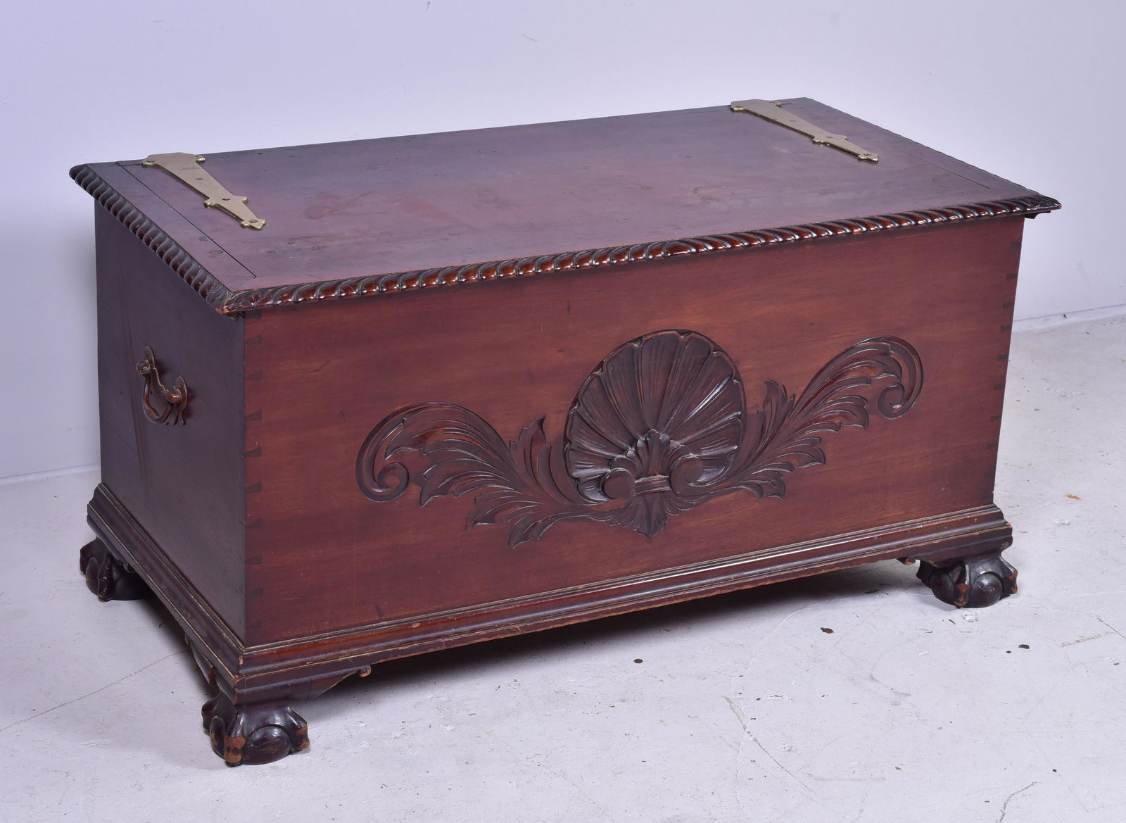 Carved mahogany Centennial Chippendale blanket chest: Carved mahogany Centennial Chippendale blanket chest, gadrooned edged top, front with shell and acanthus top, raised on ball and claw feet, dovetailed case, 48" w x 24" d x 24" h