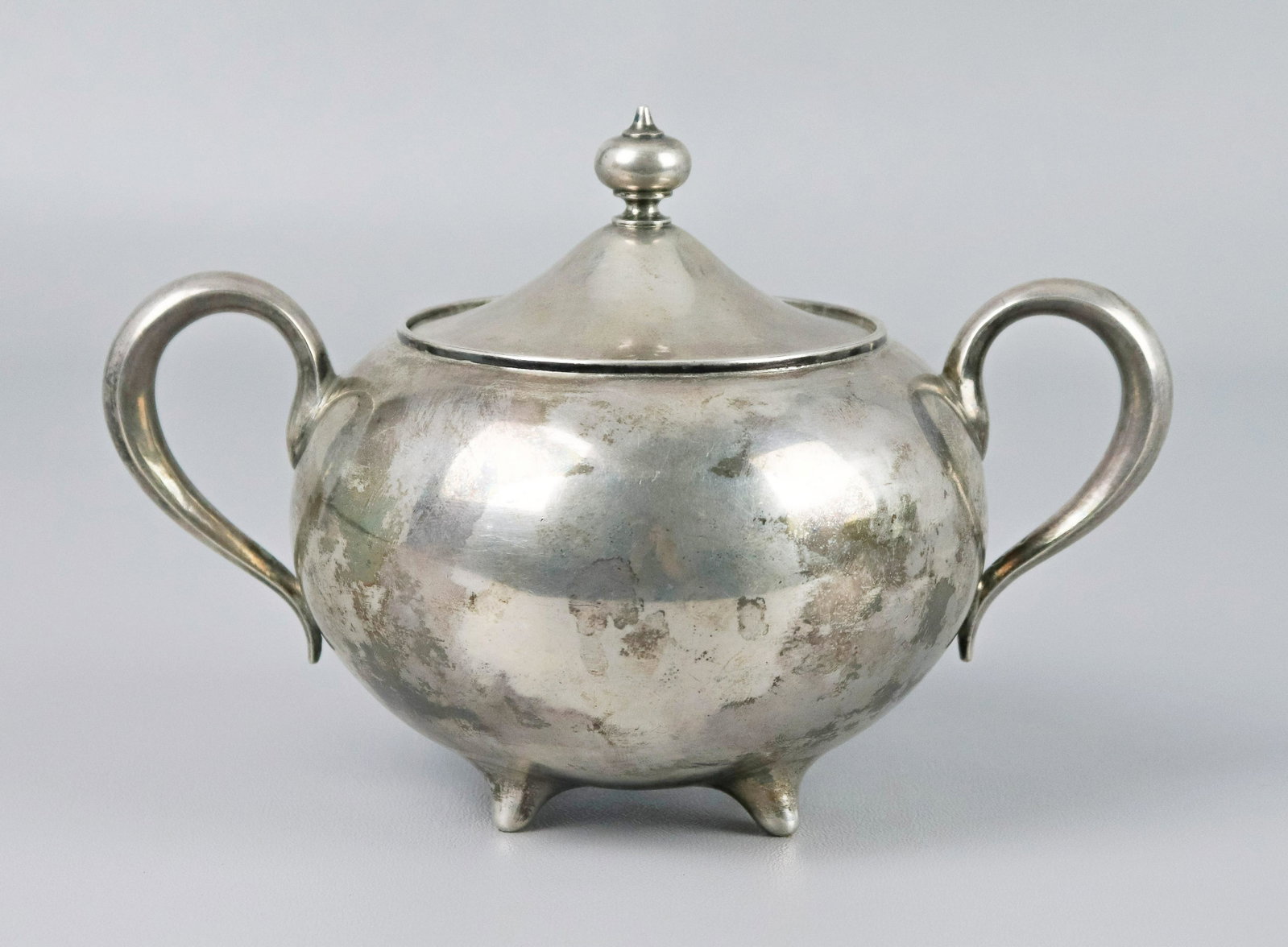 Russian Silver Sugar Dish: Russian silver sugar dish on pinched feet, double handles at sides and finial topped lid, interior with gilt wash. Item hallmarked with Imperial Eagle, 84, Moscow mark, A. followed by illegible mark, 
