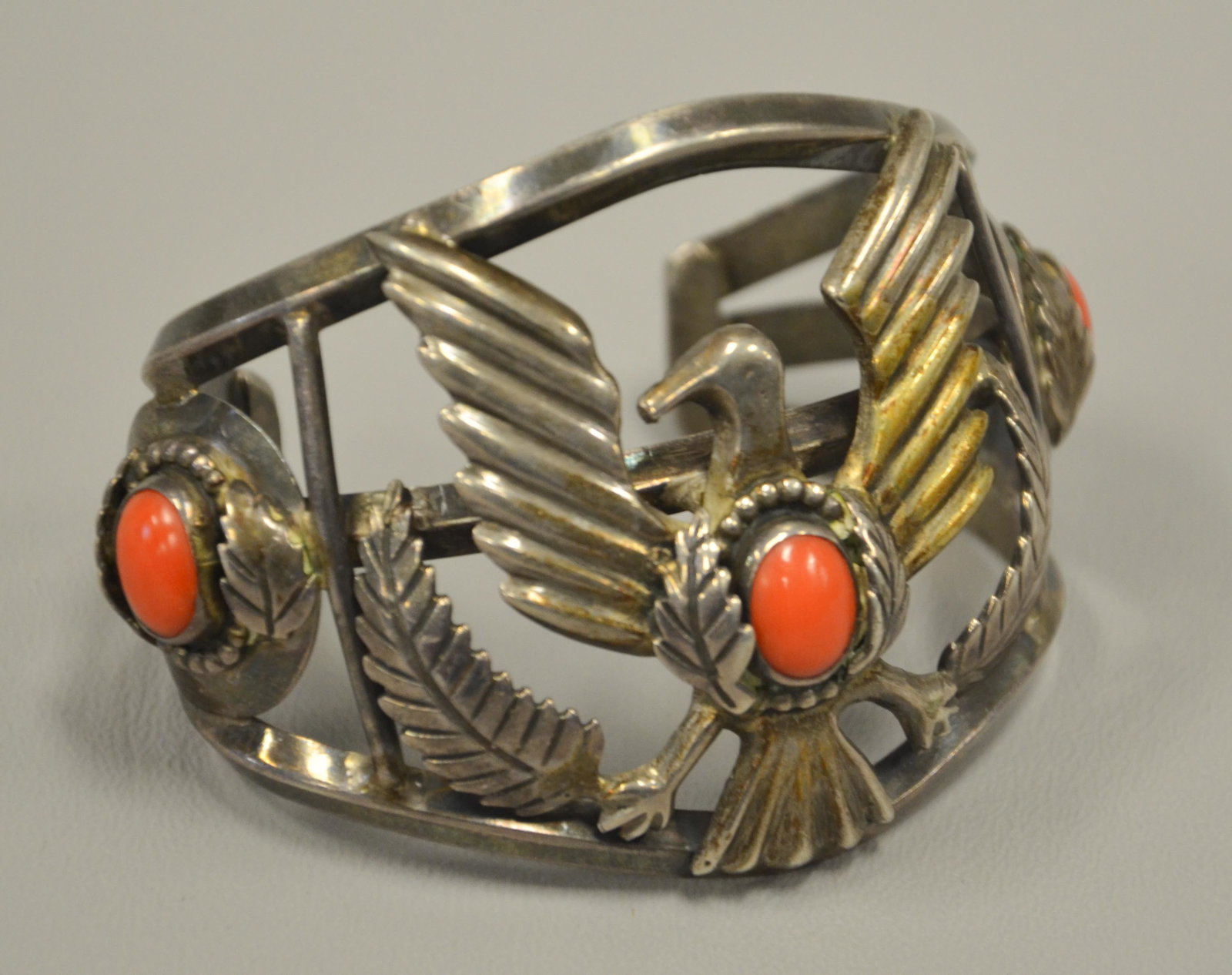 Native American Silver Coral Bangle Cuff: Unmarked Native American Silver & Coral Bangle, spread wing eagle with feathers, 2 1/2" w, 2 3/4" x 2" inside, 2.81 TO