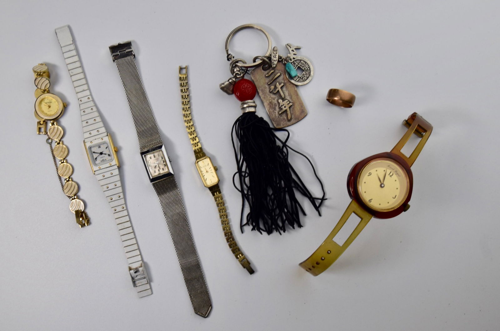 Watches, Key Chain, and Gold Band Ring: (5) Ladies Watches, (1) Keychain, (1) 7.5mm wide gold band testing at 14K, 2.8 Dwt. sz. 8.5