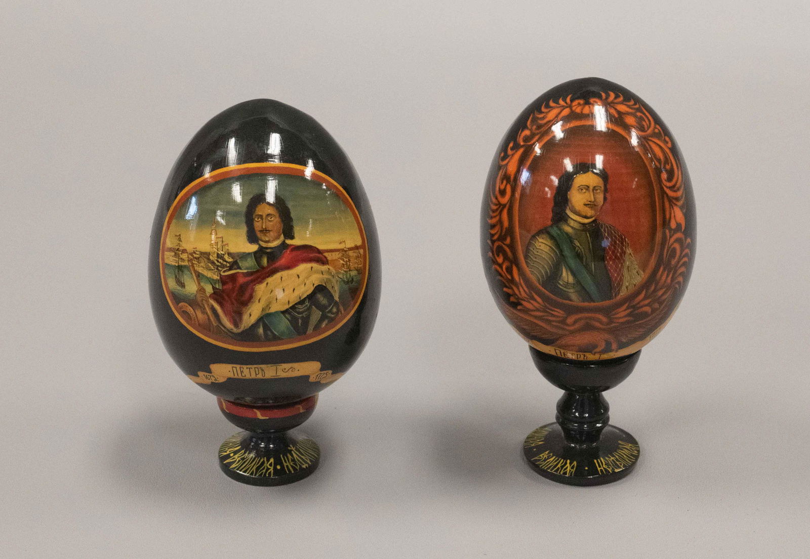 (2) Russian Lacquer Portrait Eggs: (2) Russian lacquer portrait eggs depicting Peter I, Peter the Great, (1) egg with portrait at center, with naval ships and telescope in hand, reference to his groundwork for the Imperial Russian Navy