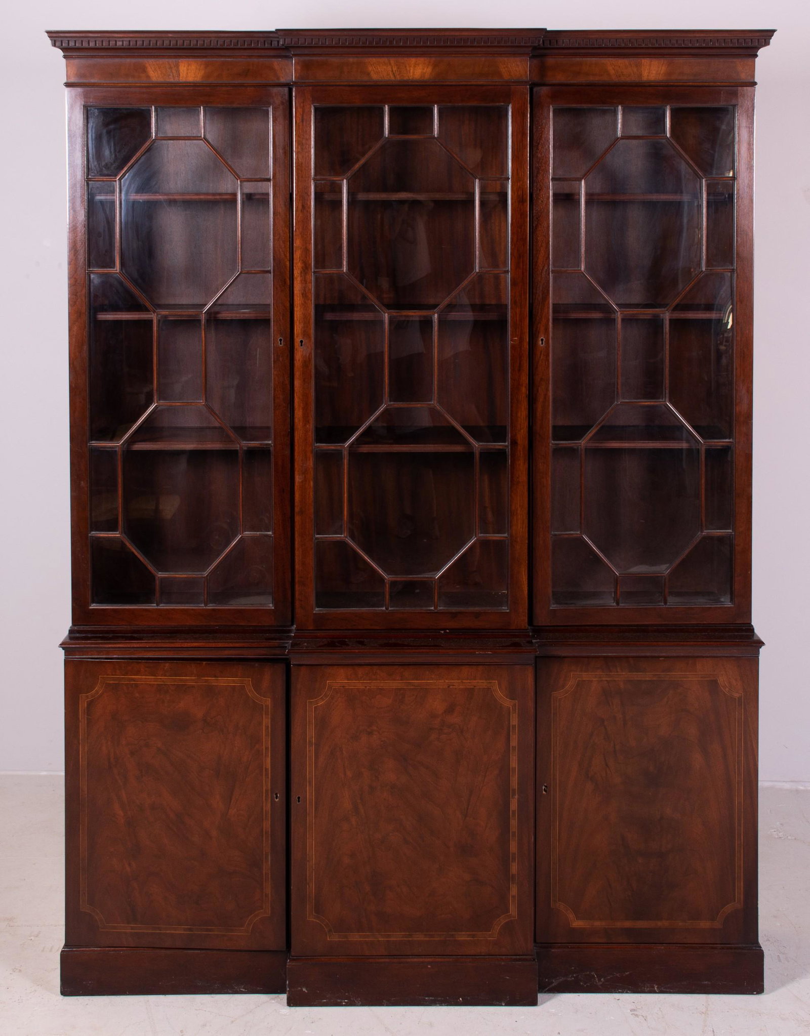 2-pc Baker Mahogany Georgian style breakfront: 2-pc Baker Mahogany Georgian style breakfront, doors with individual crown glass panes, three drawers in base with banded and string inlay, 58"w x 80"h x 15"d