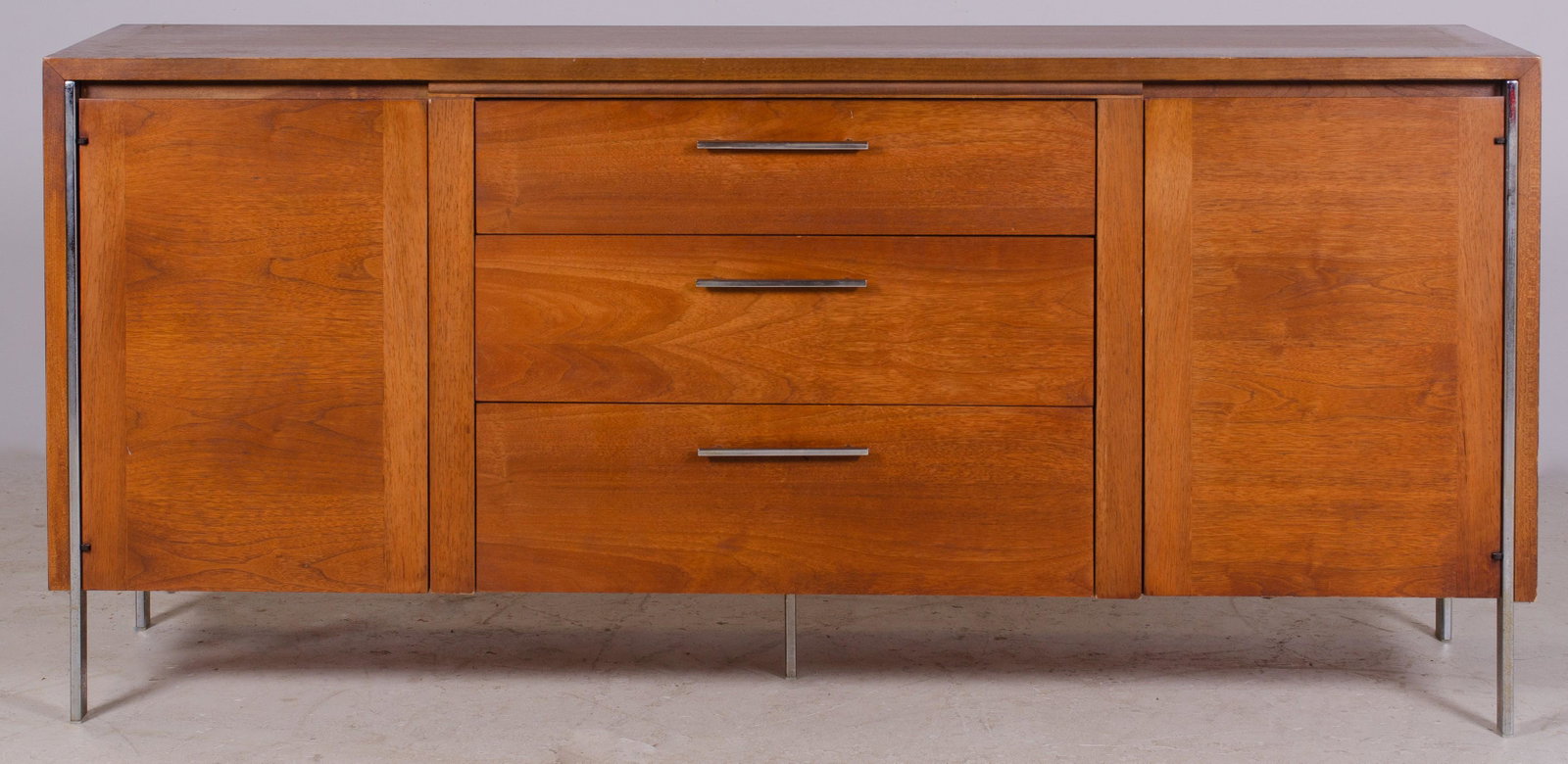 Lane Modern Design chrome and walnut sideboard: Lane Modern Design chrome and walnut sideboard, chrome legs extend along cabinet body as decorative trim, 30"h x 64"w, some pitting to chrome